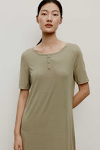 Woman in a green pajama dress