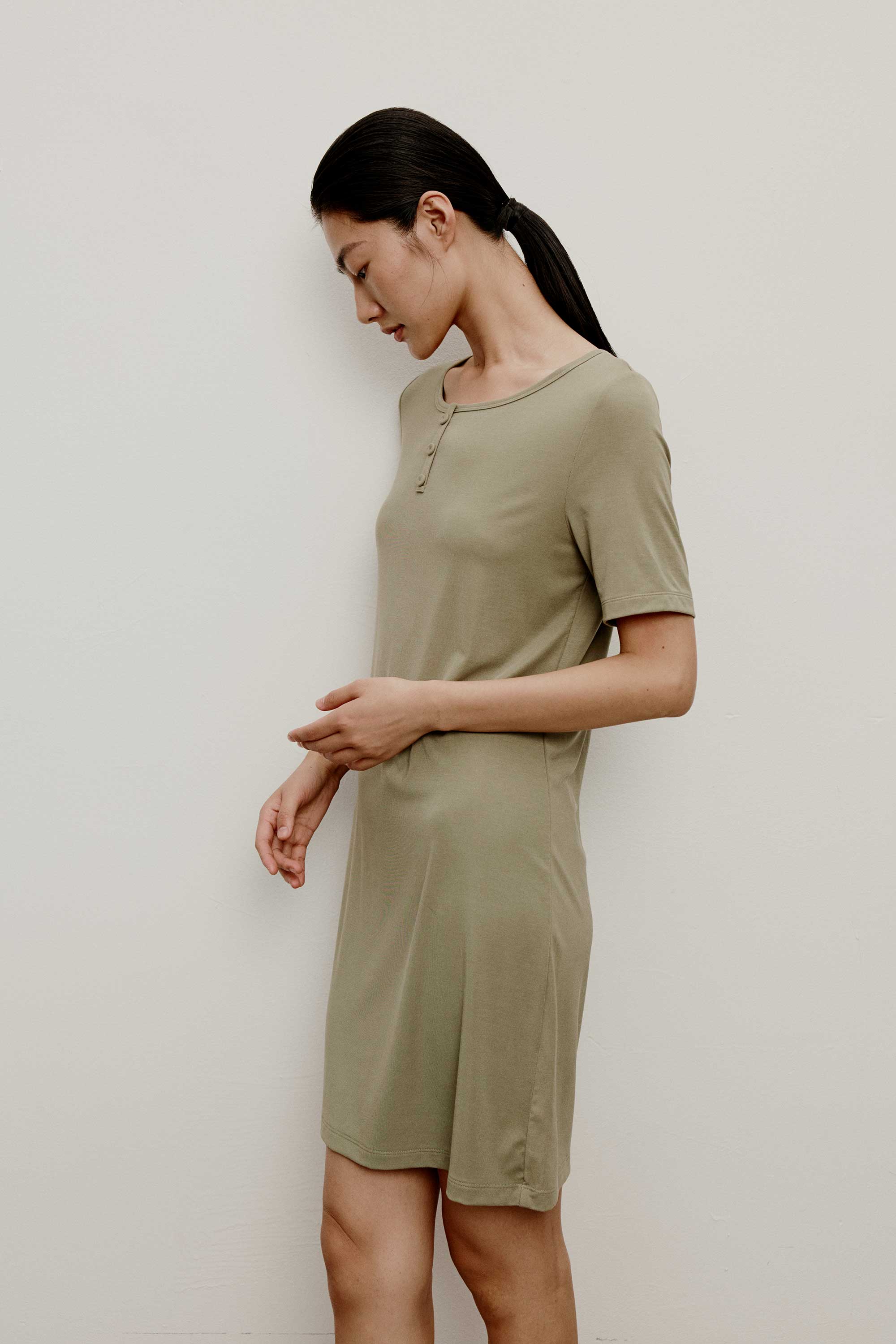 A woman wearing a green pajama dress