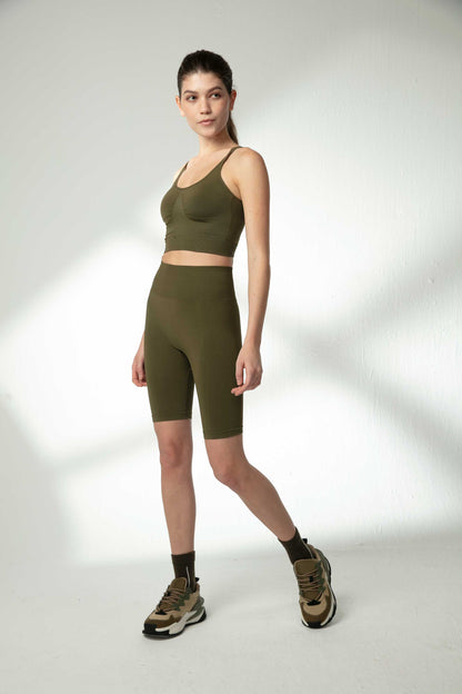 woman in green sports bra and green biker shorts