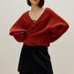 woman wearing a red wrap Cardigan and black skirt