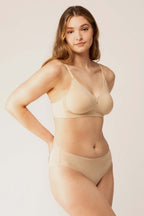 Woman wearing beige bra with plunge neckline and center cutout and matching briefs. Brazilian Sand color. 