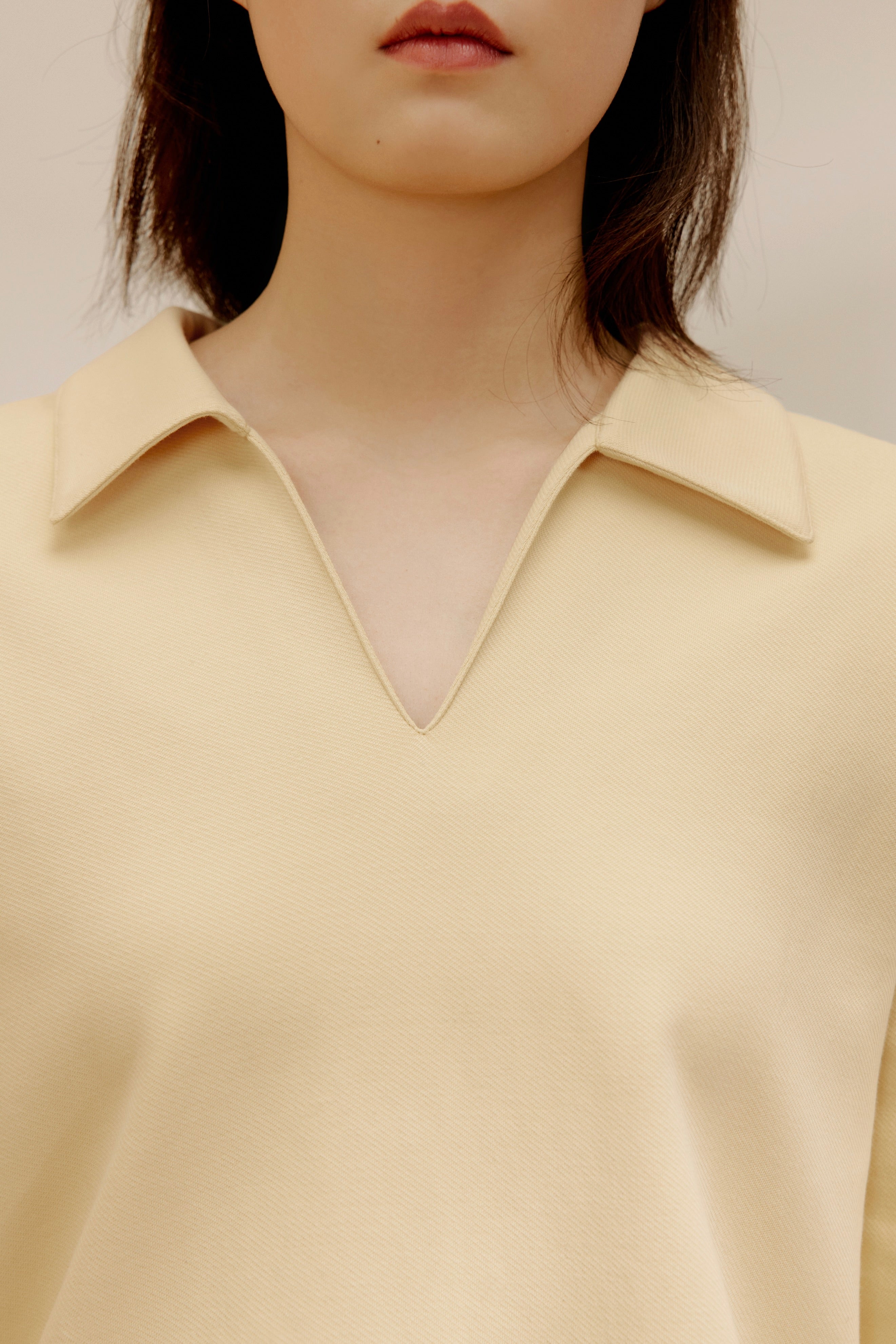 close up view of women in the yellow polo shirt