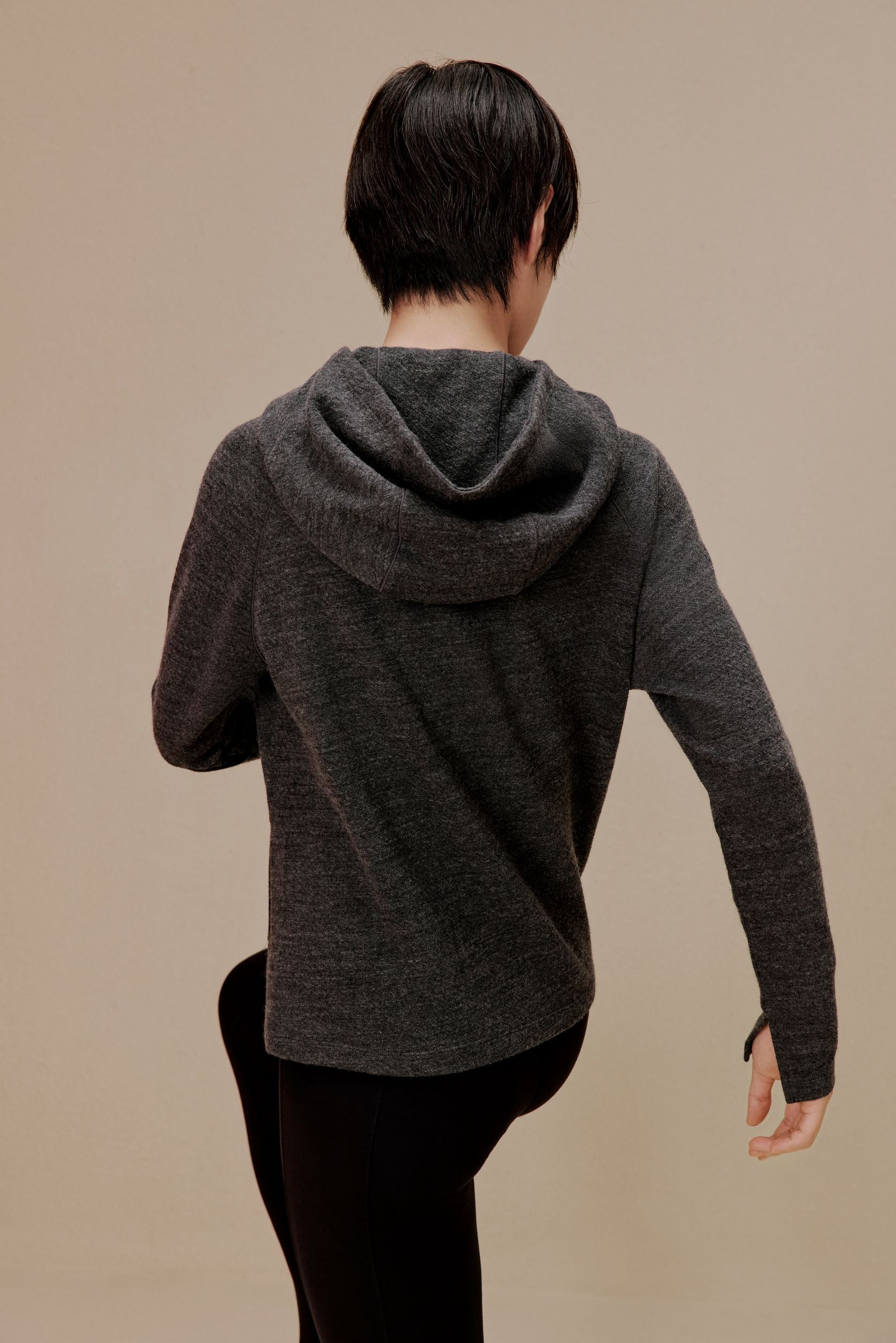 Back of woman wearing black jacket and pants
