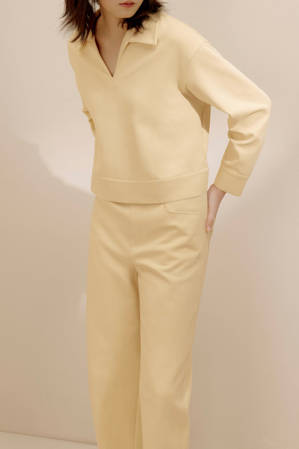 women in the yellow polo shirt and pants