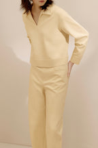 women in the yellow polo shirt and pants
