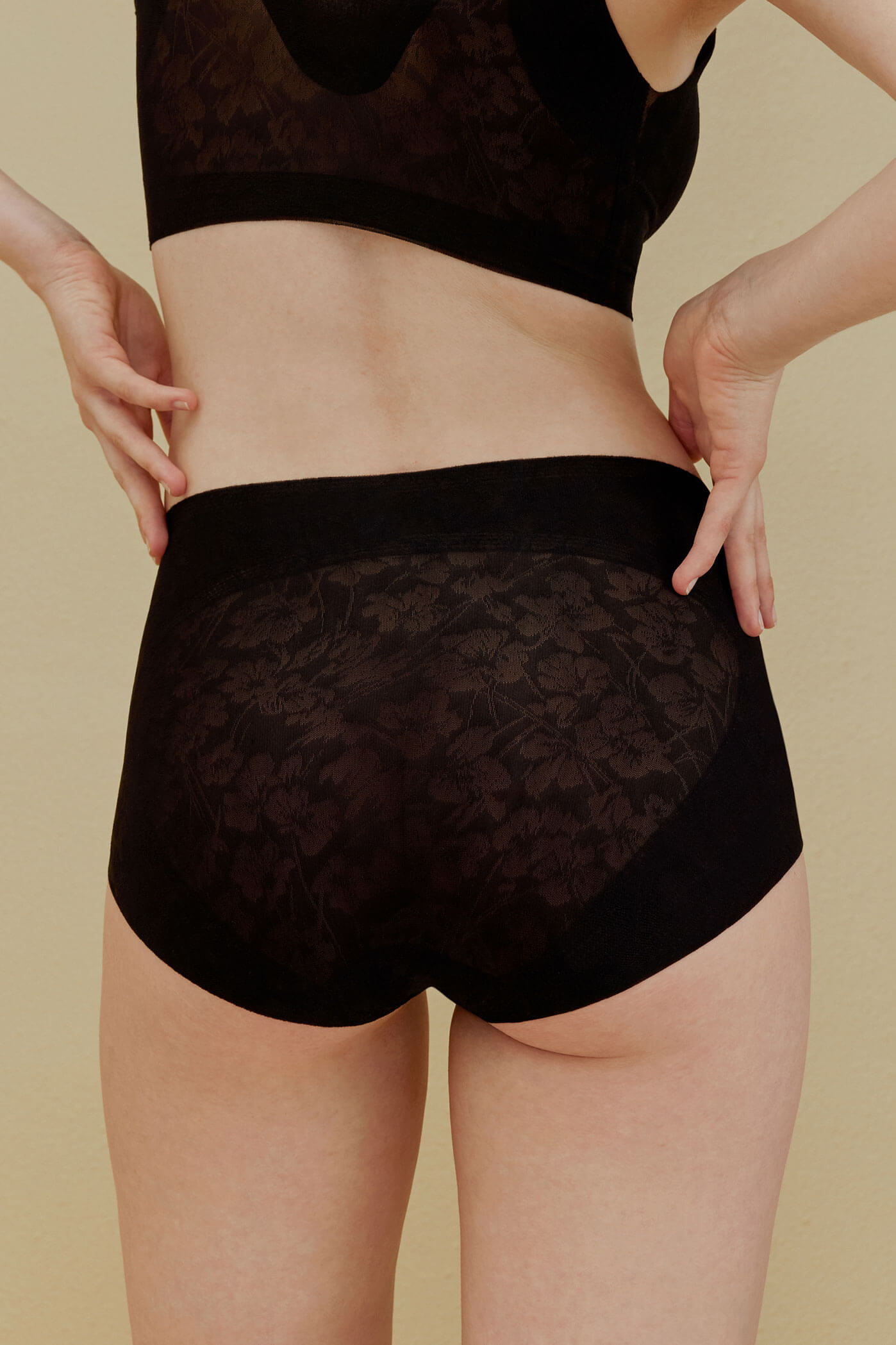 back of woman in black brief
