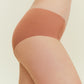 Side view of woman wearing rust-colored underwear