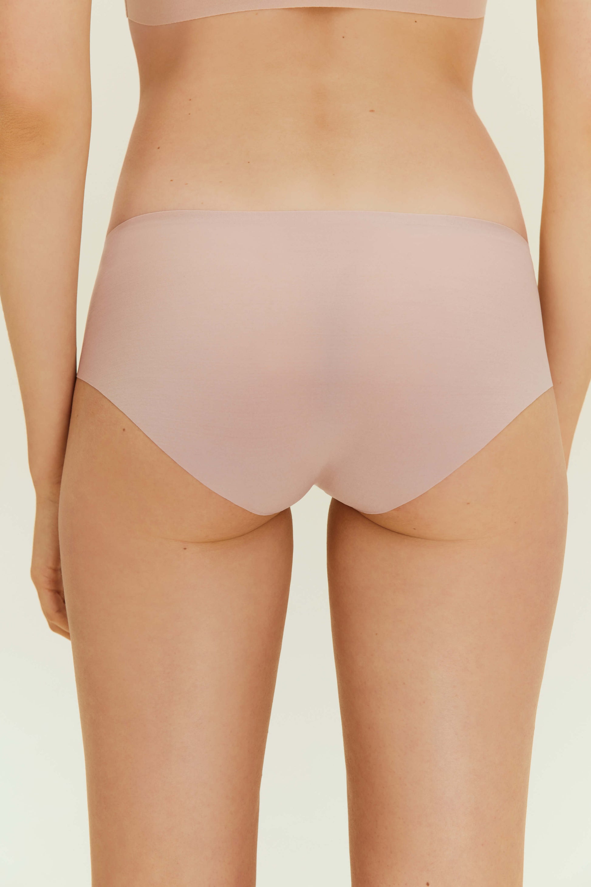 Back view of woman wearing beige underwear