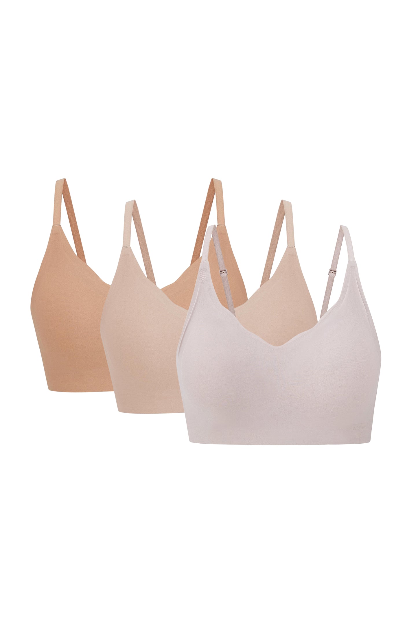 three bras in tan, beige, and light pink