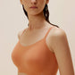 woman in maple syrup color bra