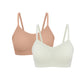 Flat lay image of off-white and tan spaghetti strap bras