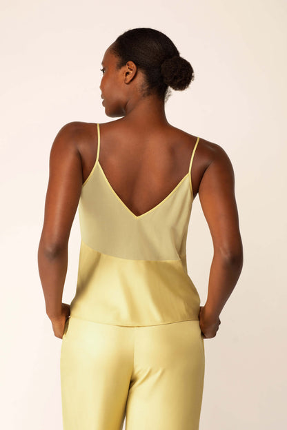 Back view of model wearing silk blend light green V-neck tank top.