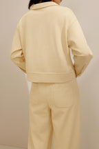 back of the women in the yellow polo shirt and pants