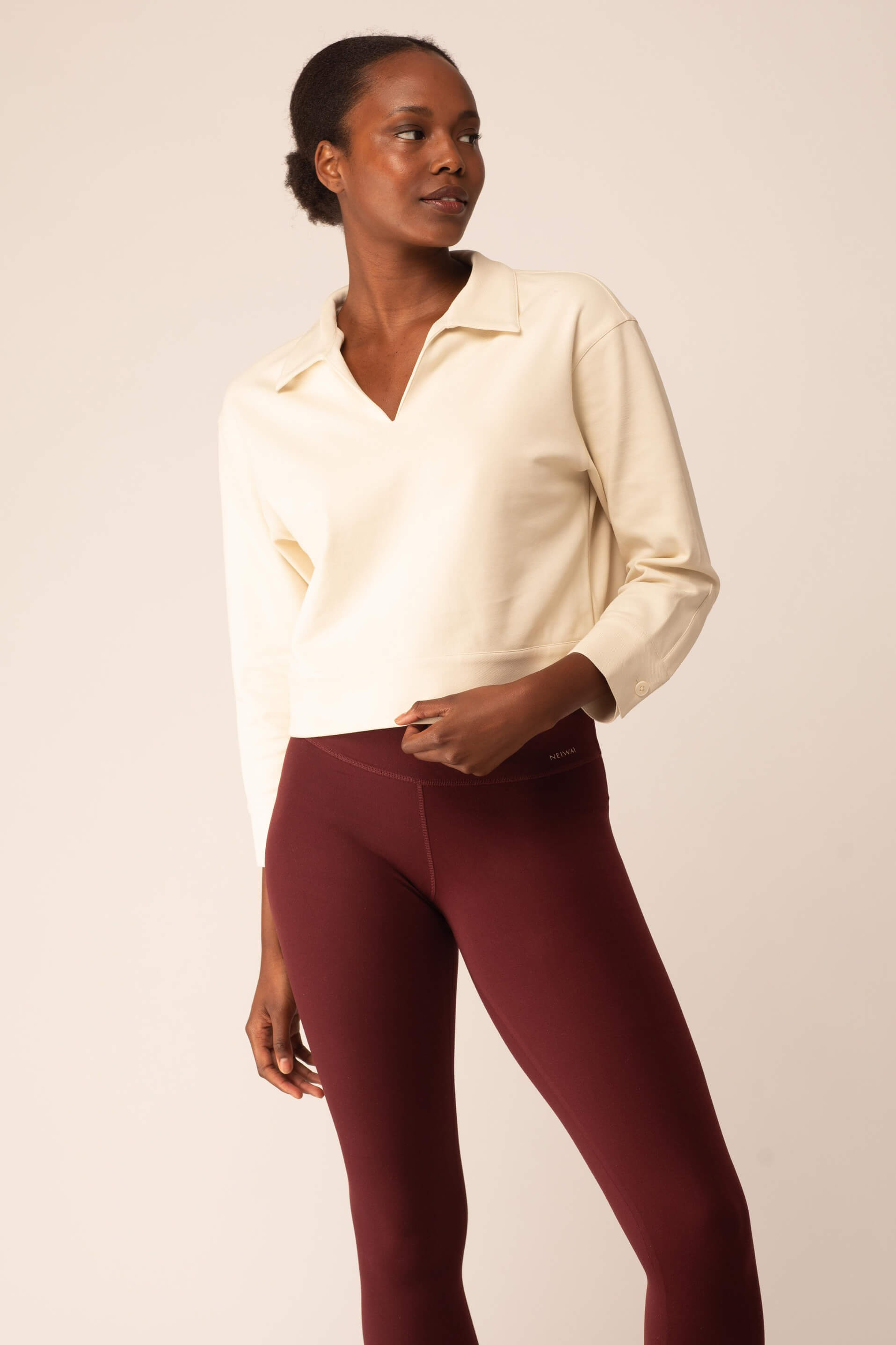 women in the white polo shirt and red leggings