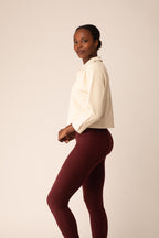 women in the white polo shirt and red leggings