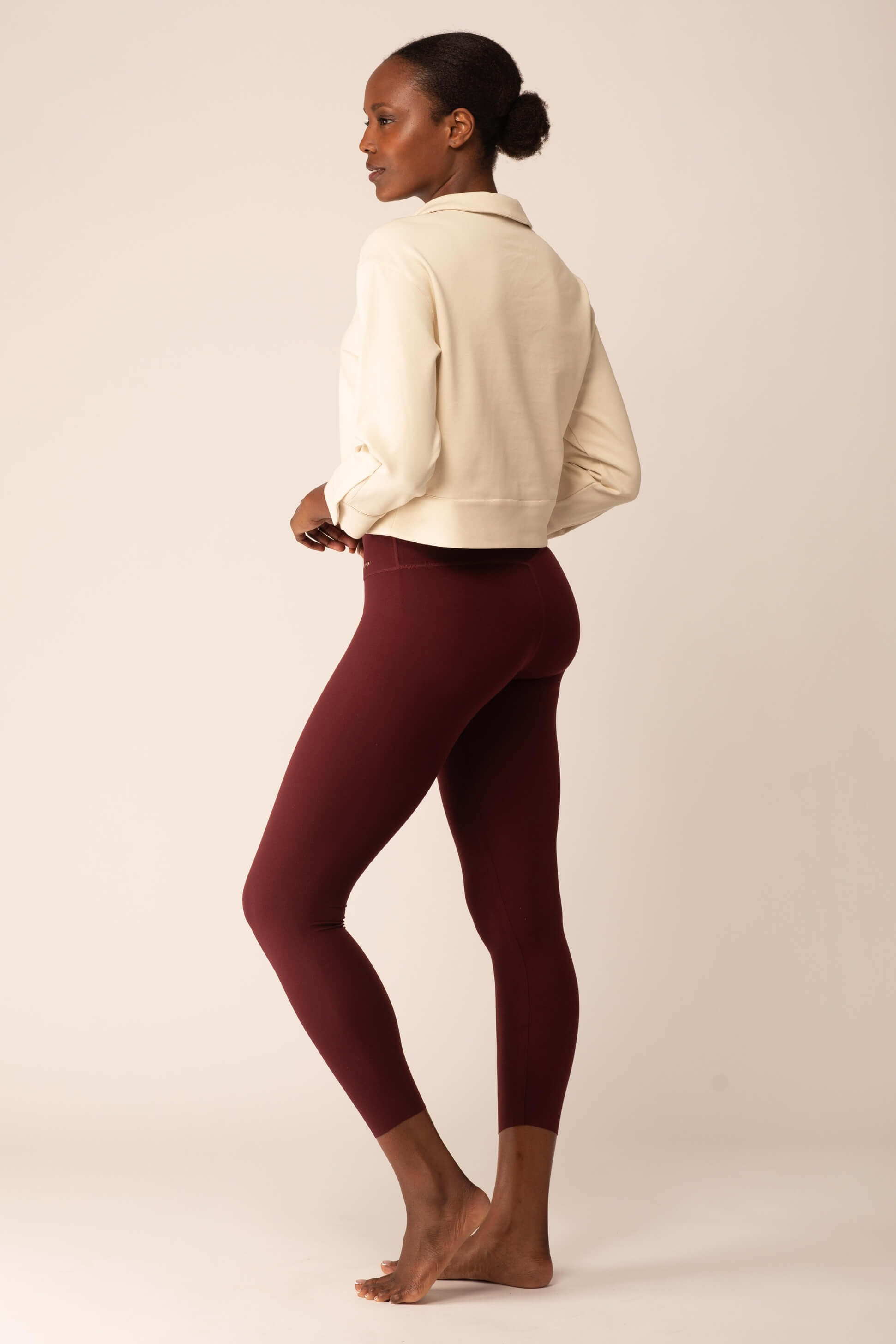 back of women in the white polo shirt and red leggings