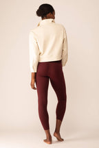 back of women in the white polo shirt and red leggings