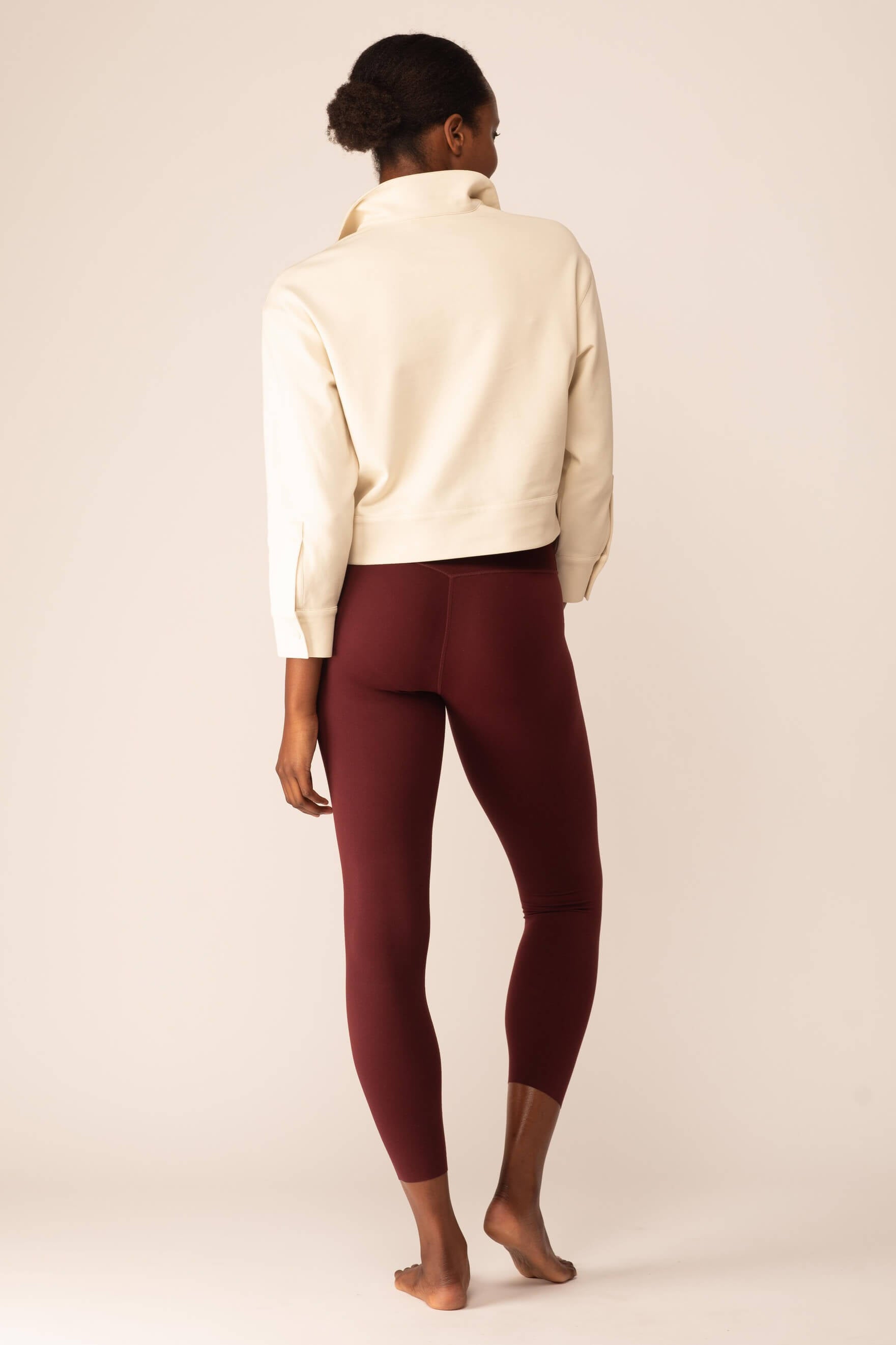 back of women in the white polo shirt and red leggings