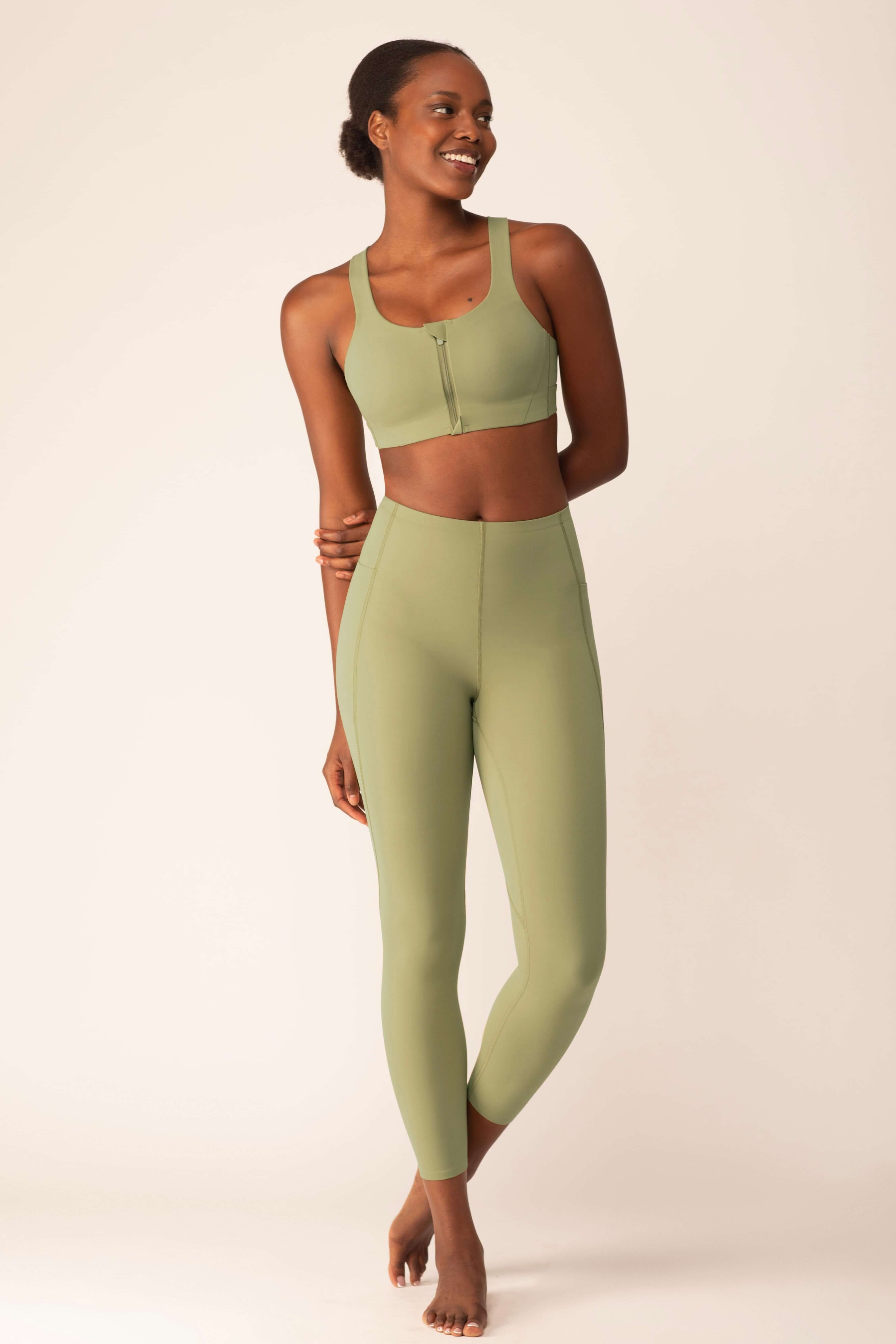 Woman wearing light green leggings and matching sports bra