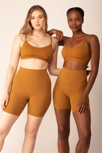 Both women were wearing tan sports bras and shorts.