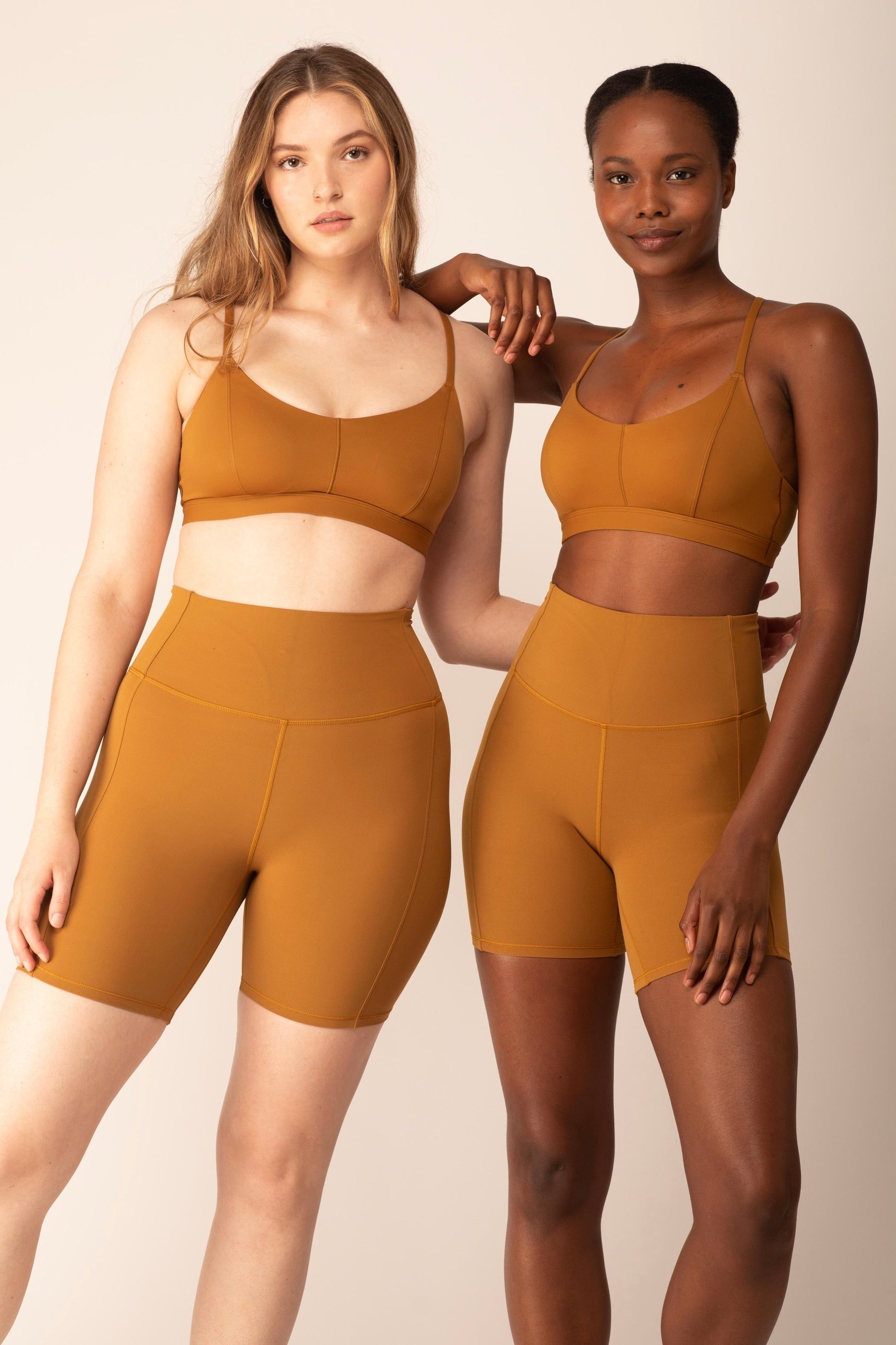 Both women were wearing tan sports bras and shorts.