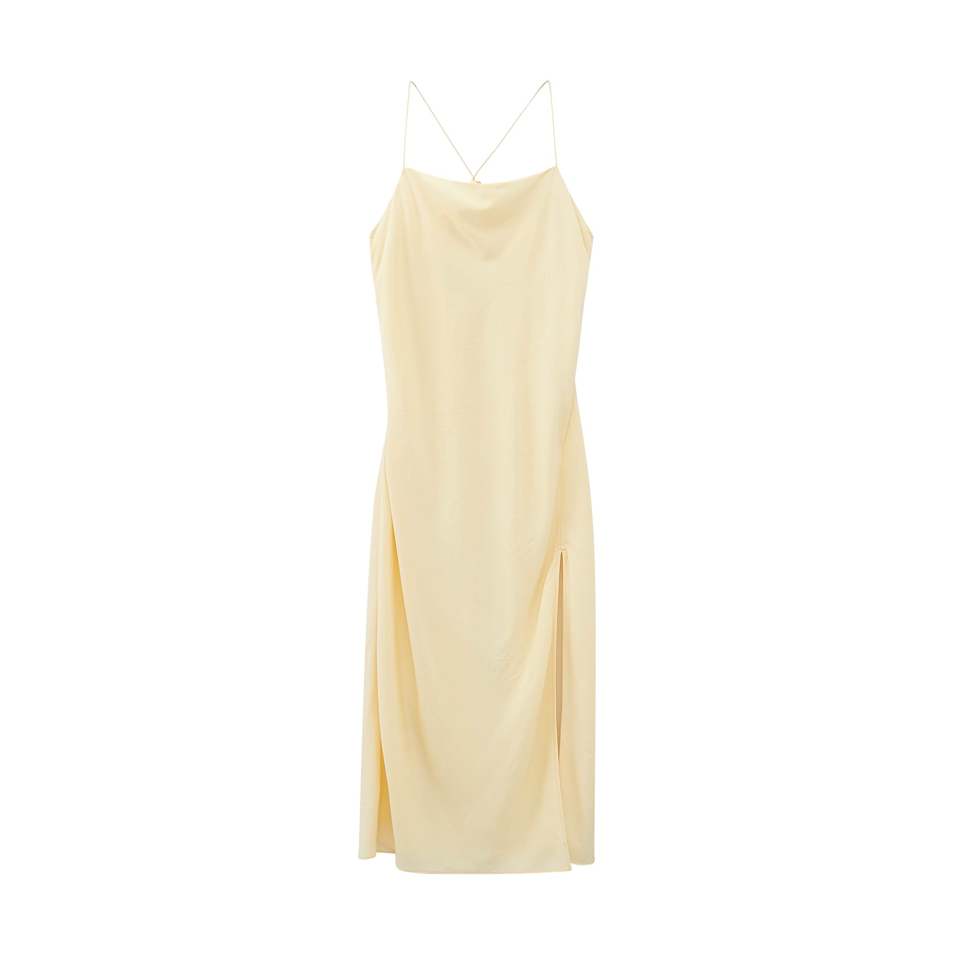 Flat lay image of front of cream colored dress with thin straps and high leg slits