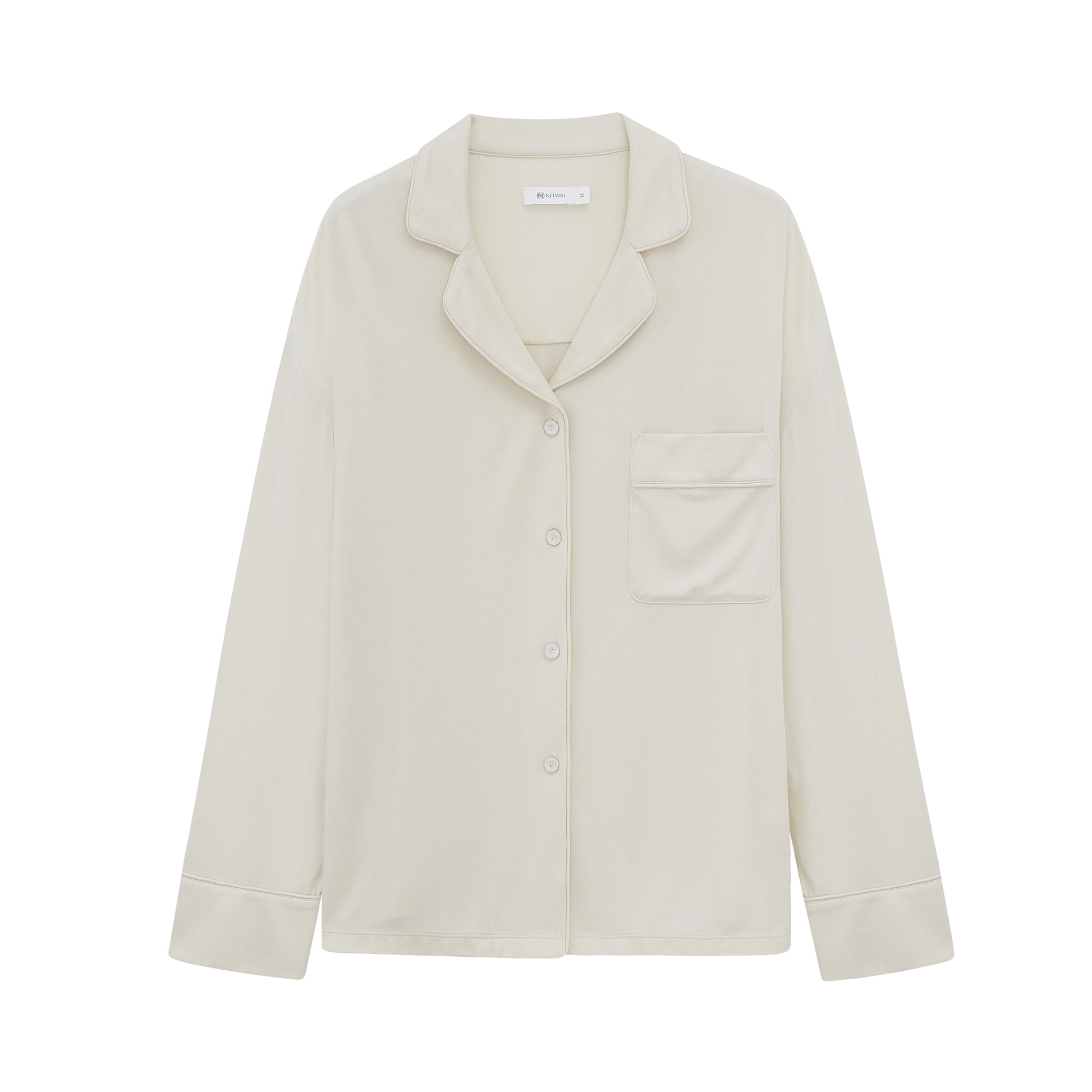Flat lay image of off-white button up pajama shirt with pocket