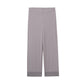 Flat lay image of light purple pajama pant with two decorative buttons at waist band