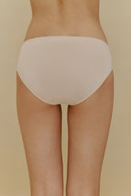 Back of woman in beige underwear