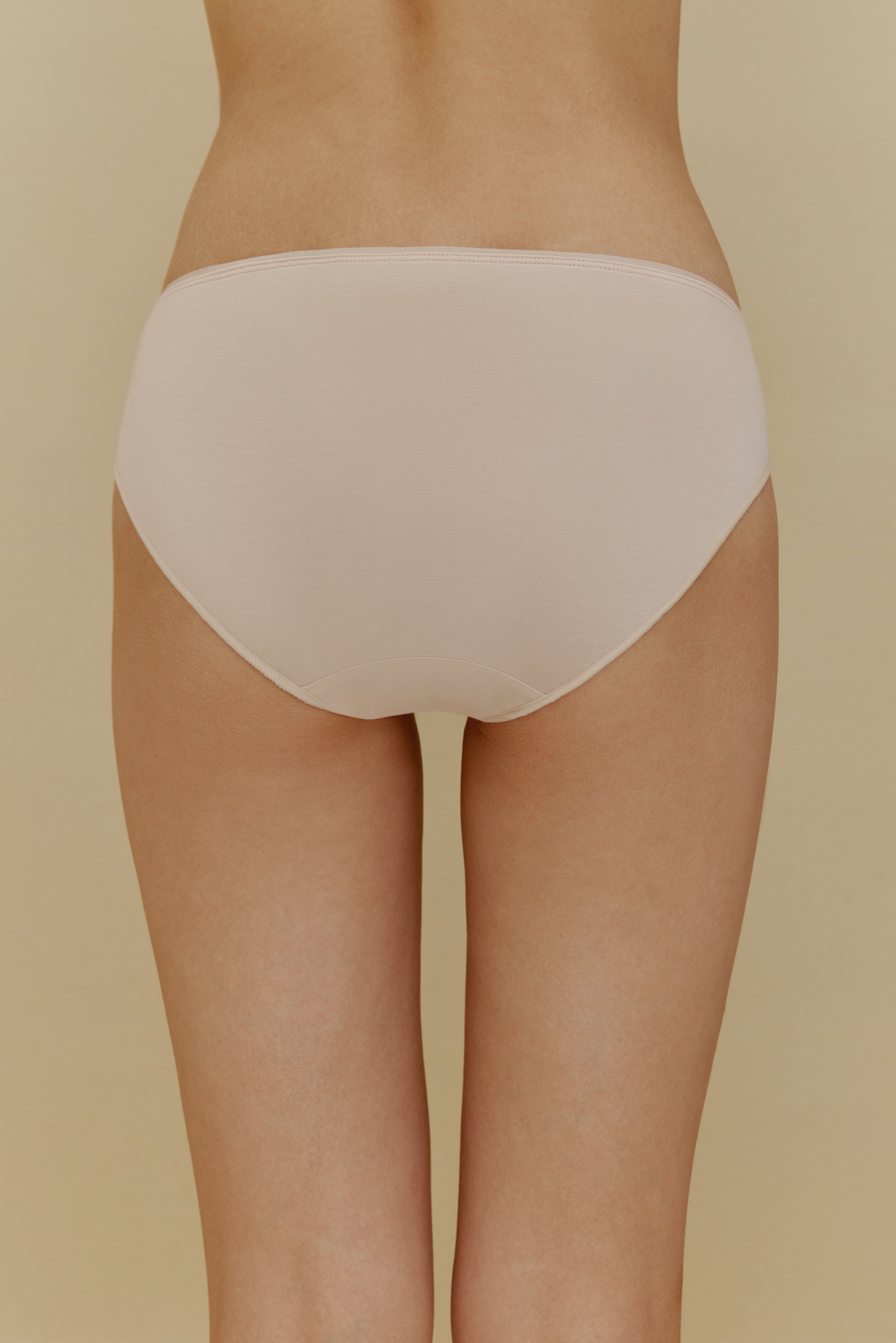 Back of woman in beige underwear