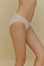 Side of woman in beige underwear