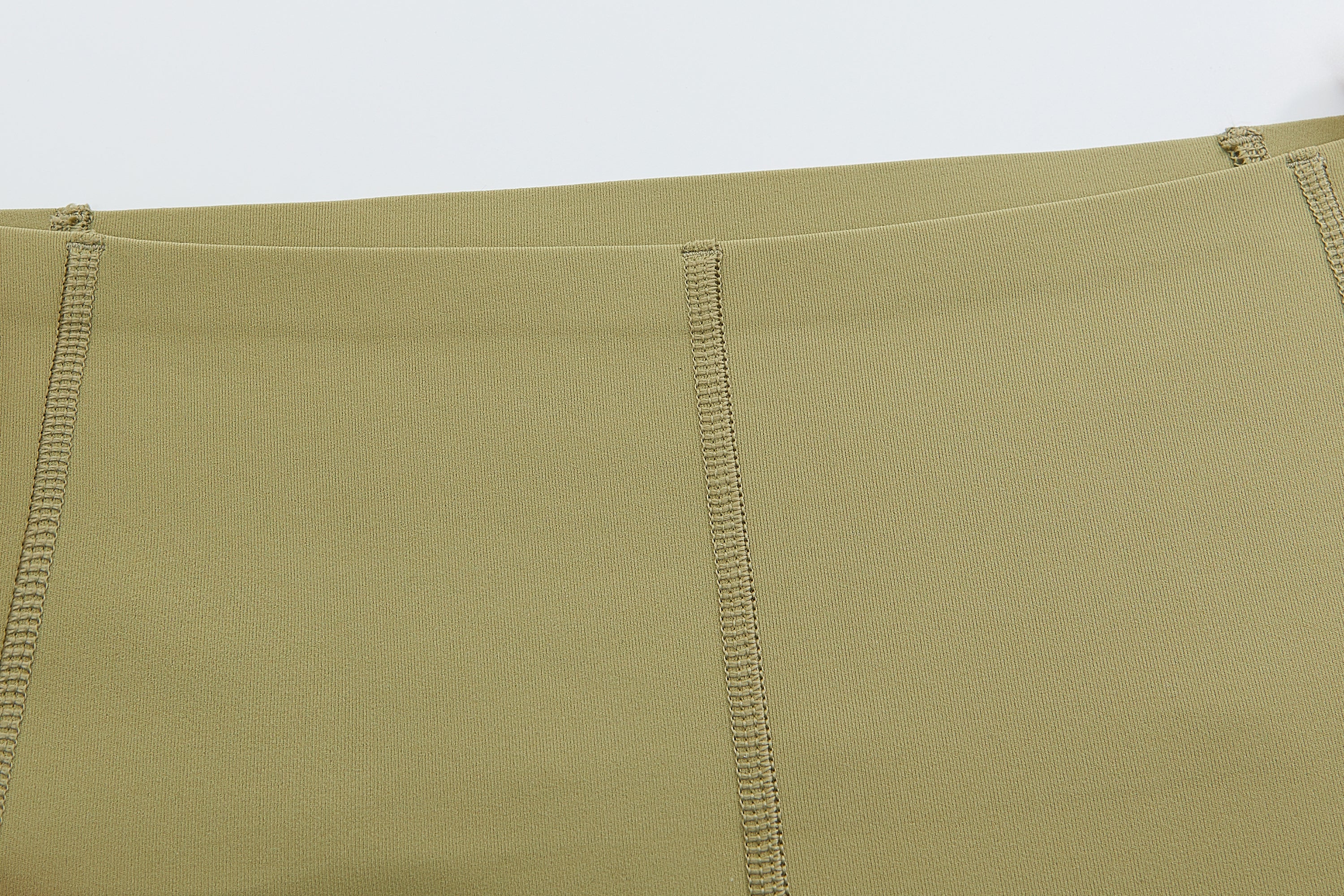 Closeup of waistband of light green leggings
