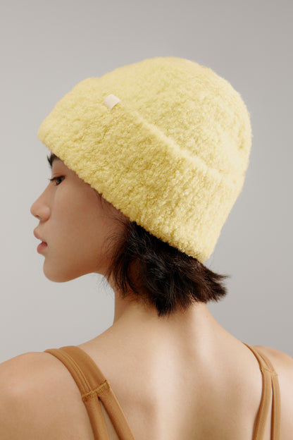 woman wearing a yellow beanie