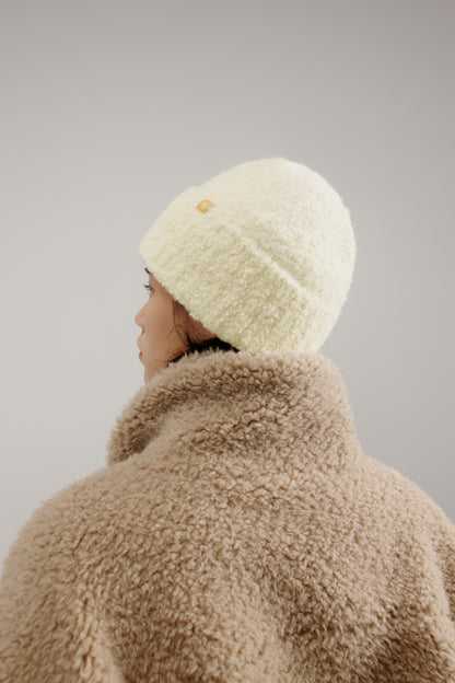 woman wearing a white beanie