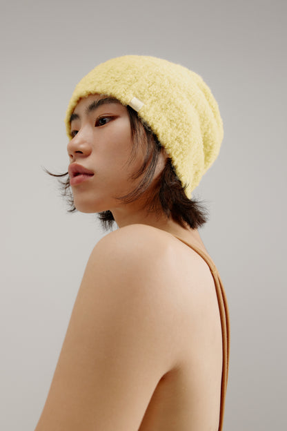 woman wearing a yellow beanie