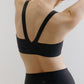 back of woman in black sports bra