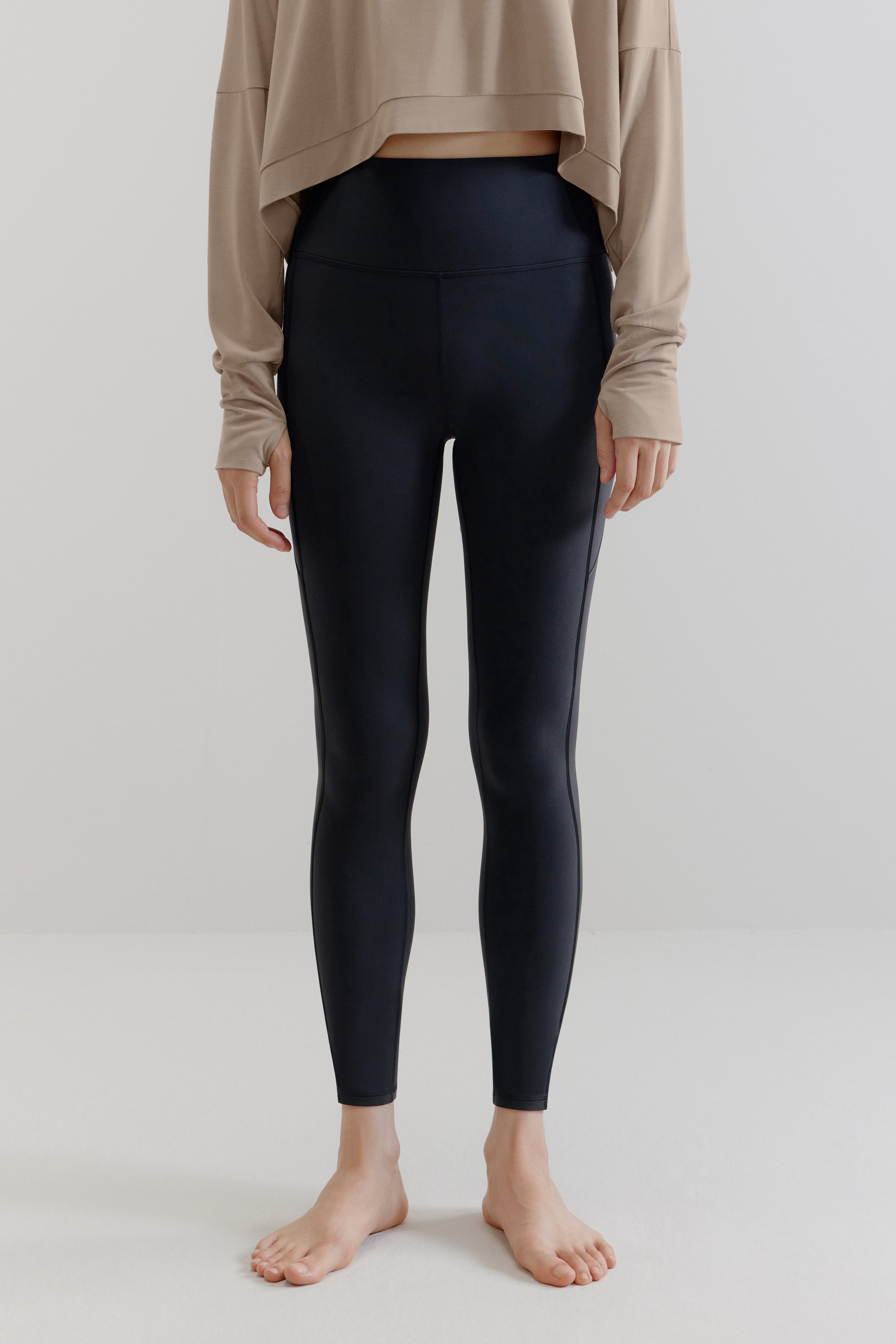 A gray long-sleeved shirt and navy leggings