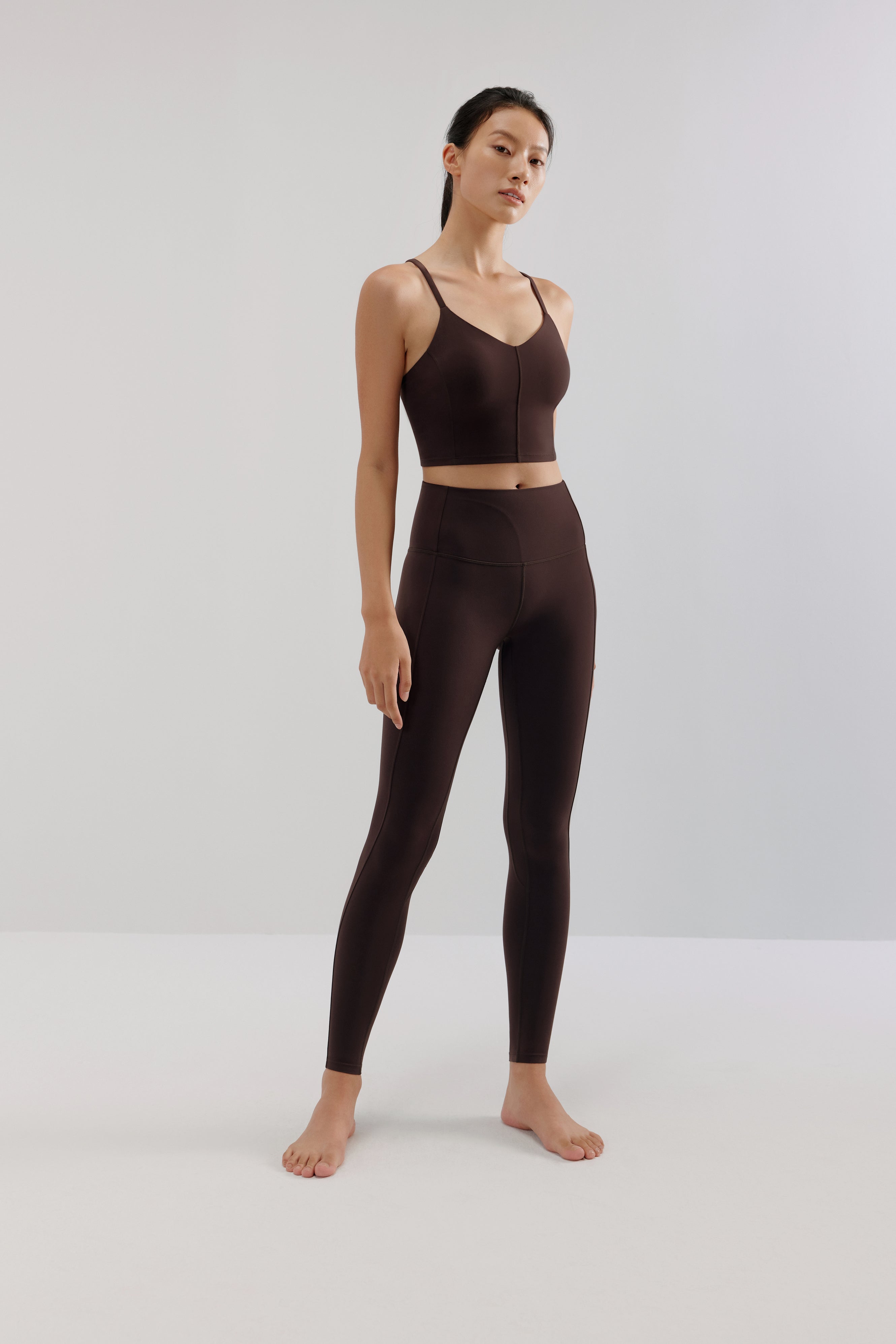 woman in brown sports bra and leggings