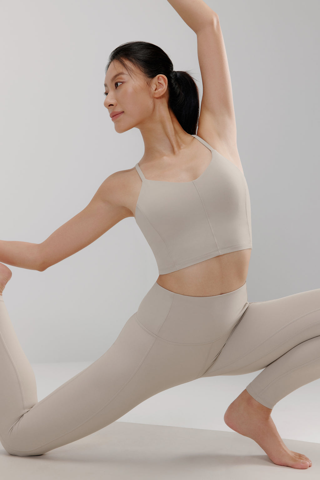 woman in grey sports bra and leggings