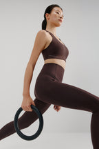 woman in brown sports bra and leggings