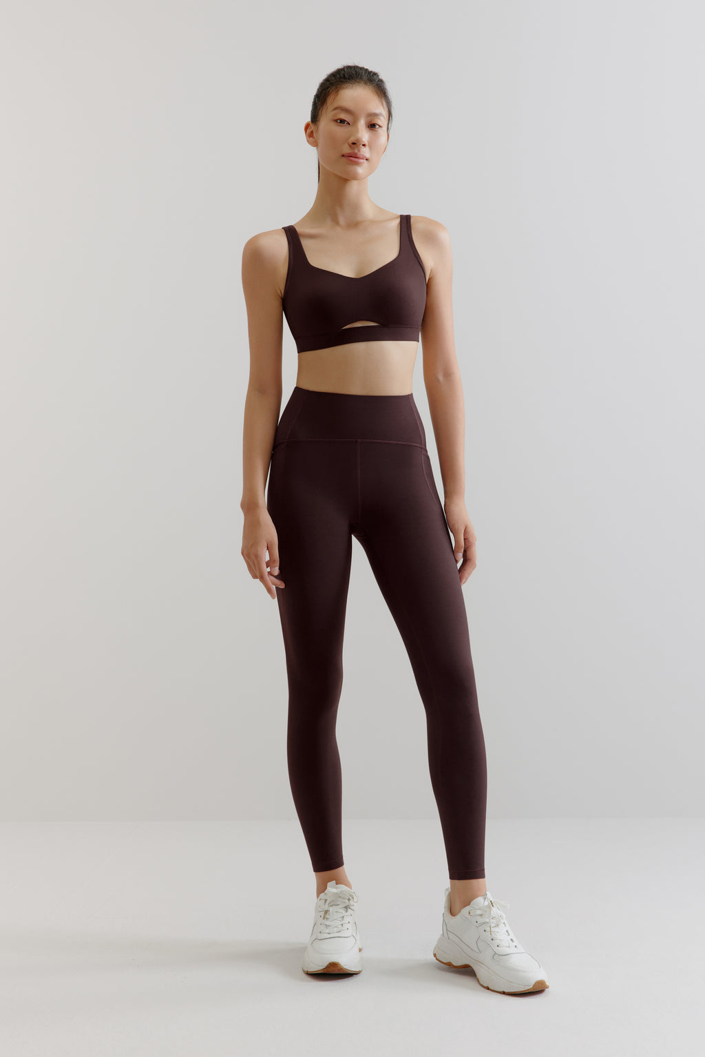 woman in brown sports bra and leggings