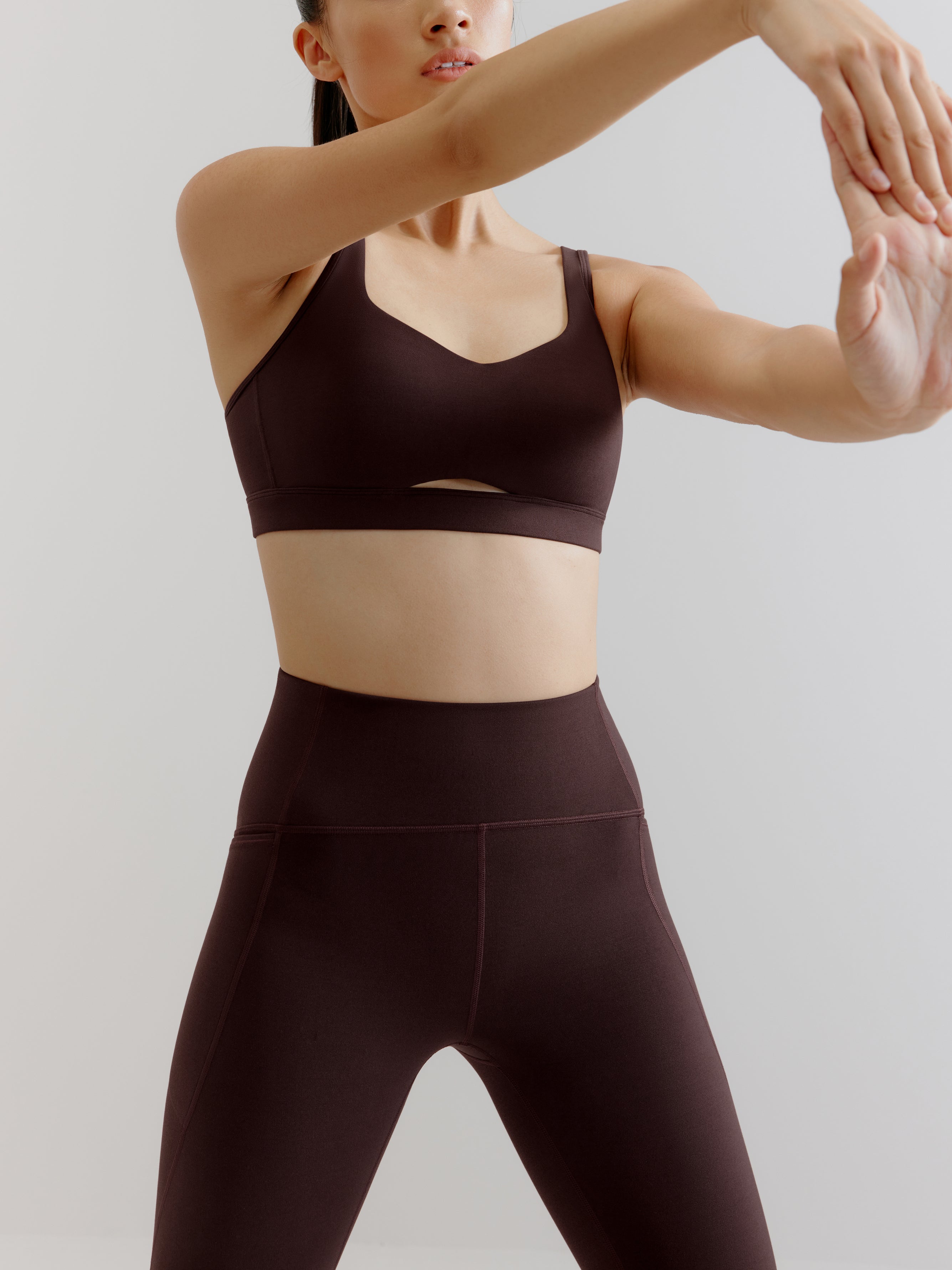 woman in brown sports bra and leggings