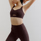 woman wearing a brown sports bra and leggings