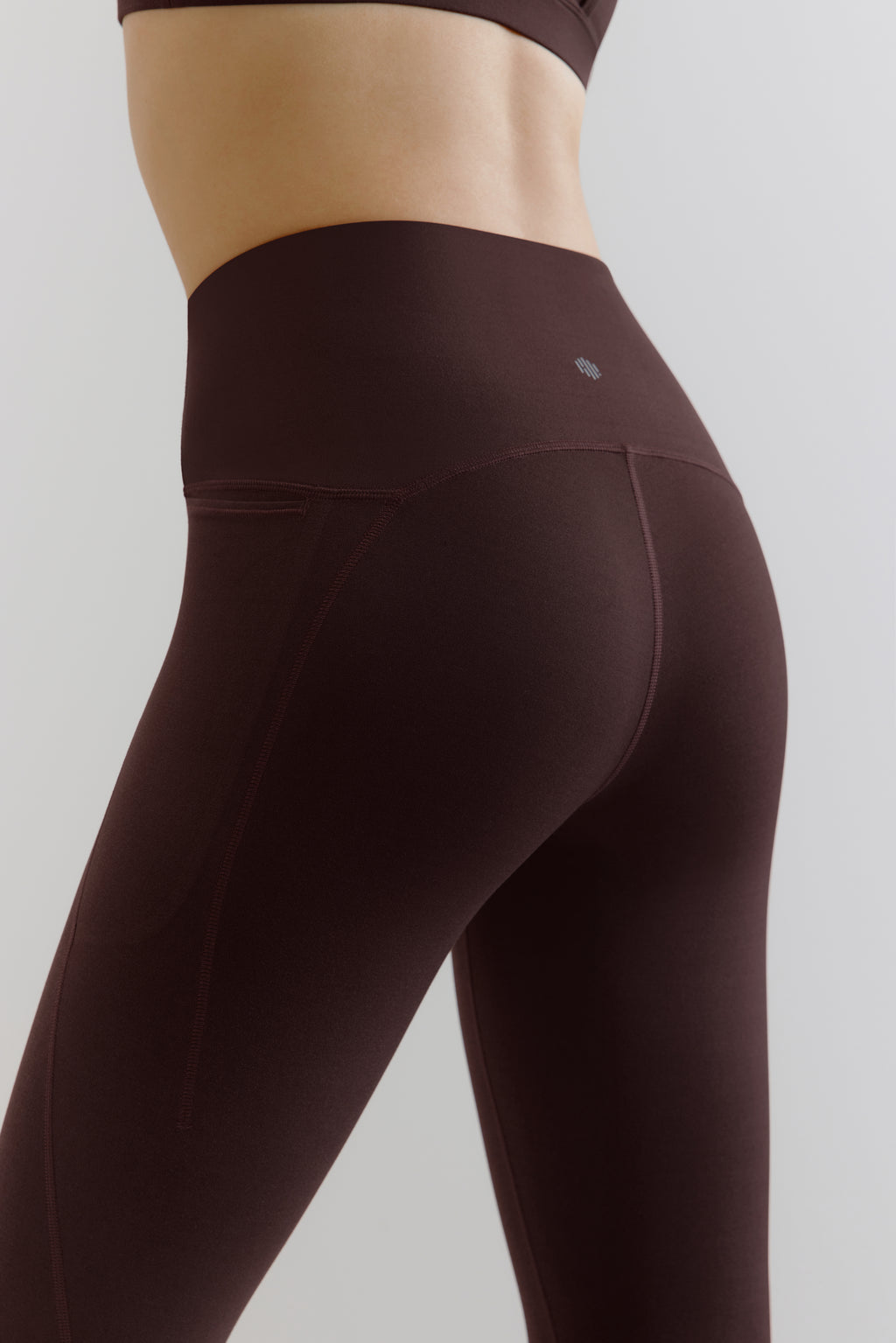 back of woman in brown leggings