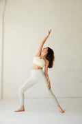 woman in cream sports bra and leggings