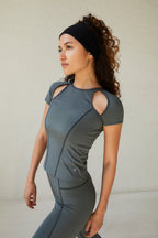 a woman wearing a dark grey t shirt and dark grey legging