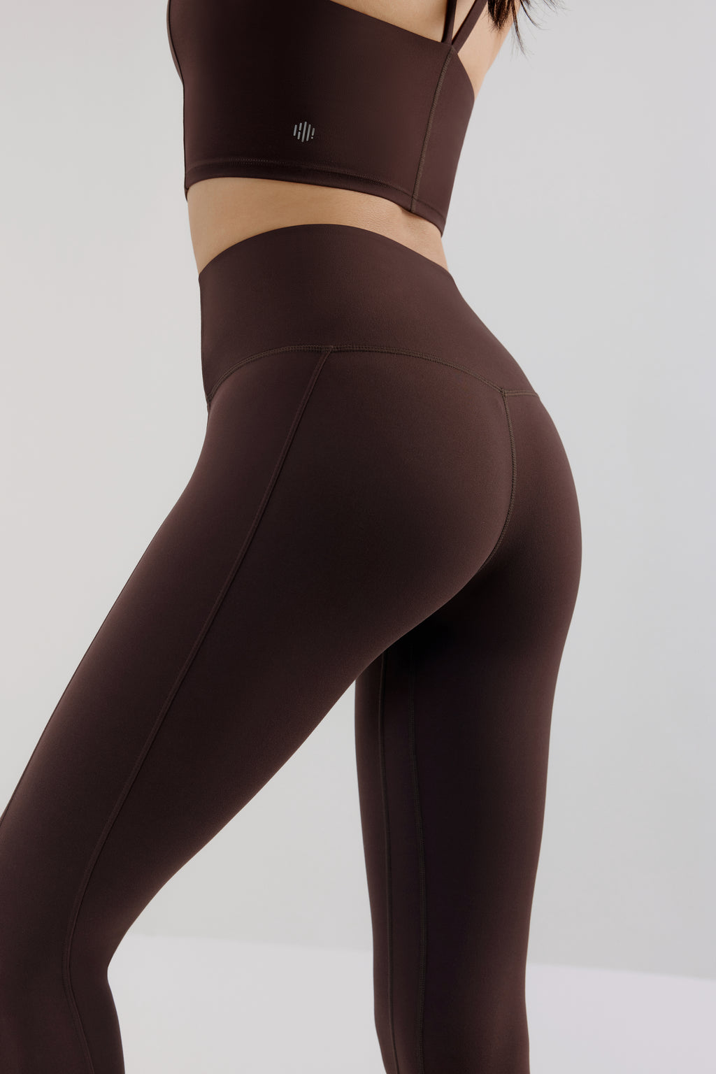 back of woman in brown leggings