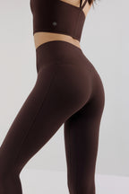 back of woman in brown leggings