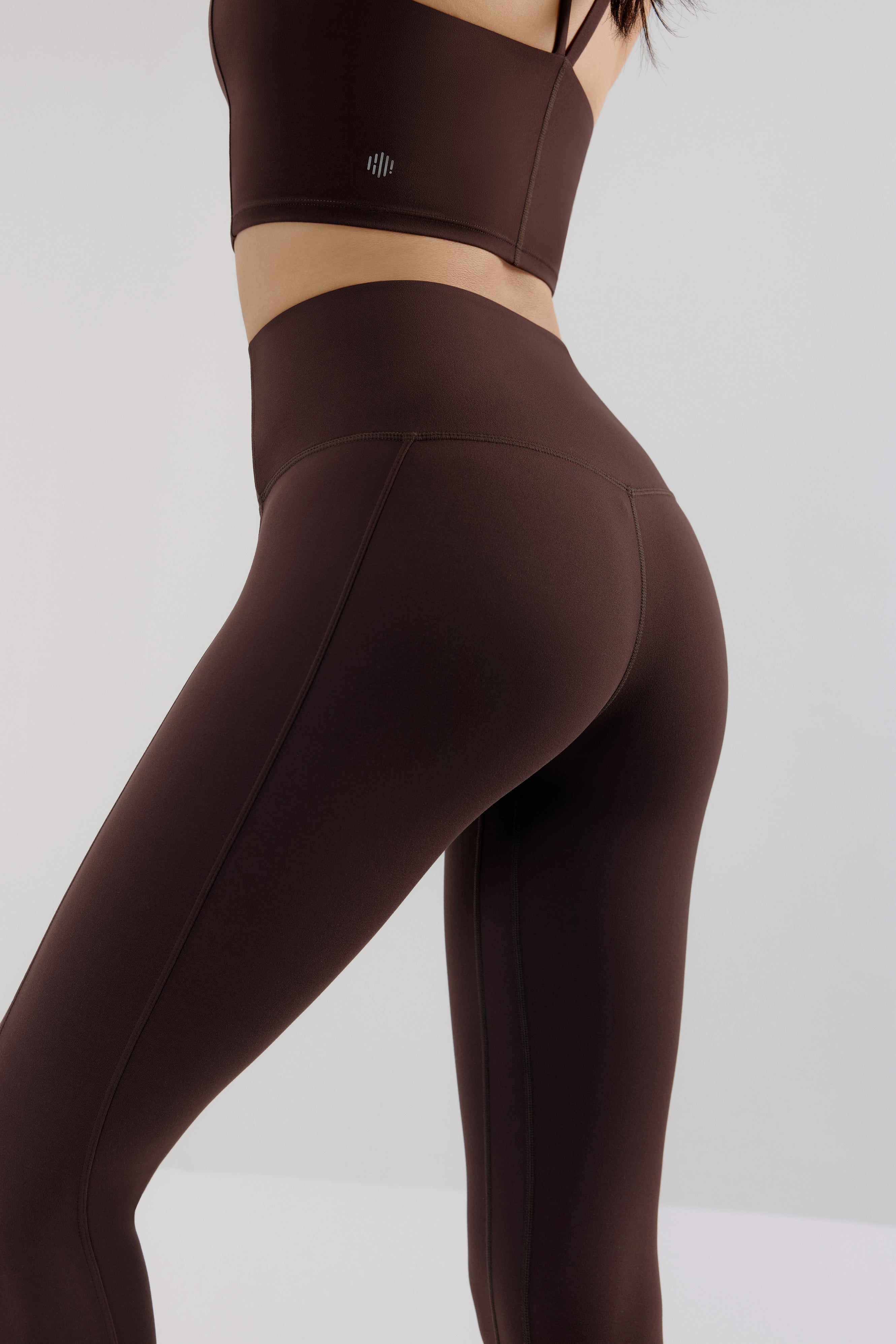 back of woman in brown leggings