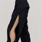 A close look of the side view of a woman wearing a pair of black tapered joggers with side slits